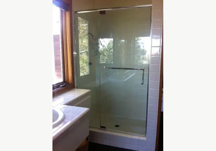 frameless shower enclosure in clear tempered glass